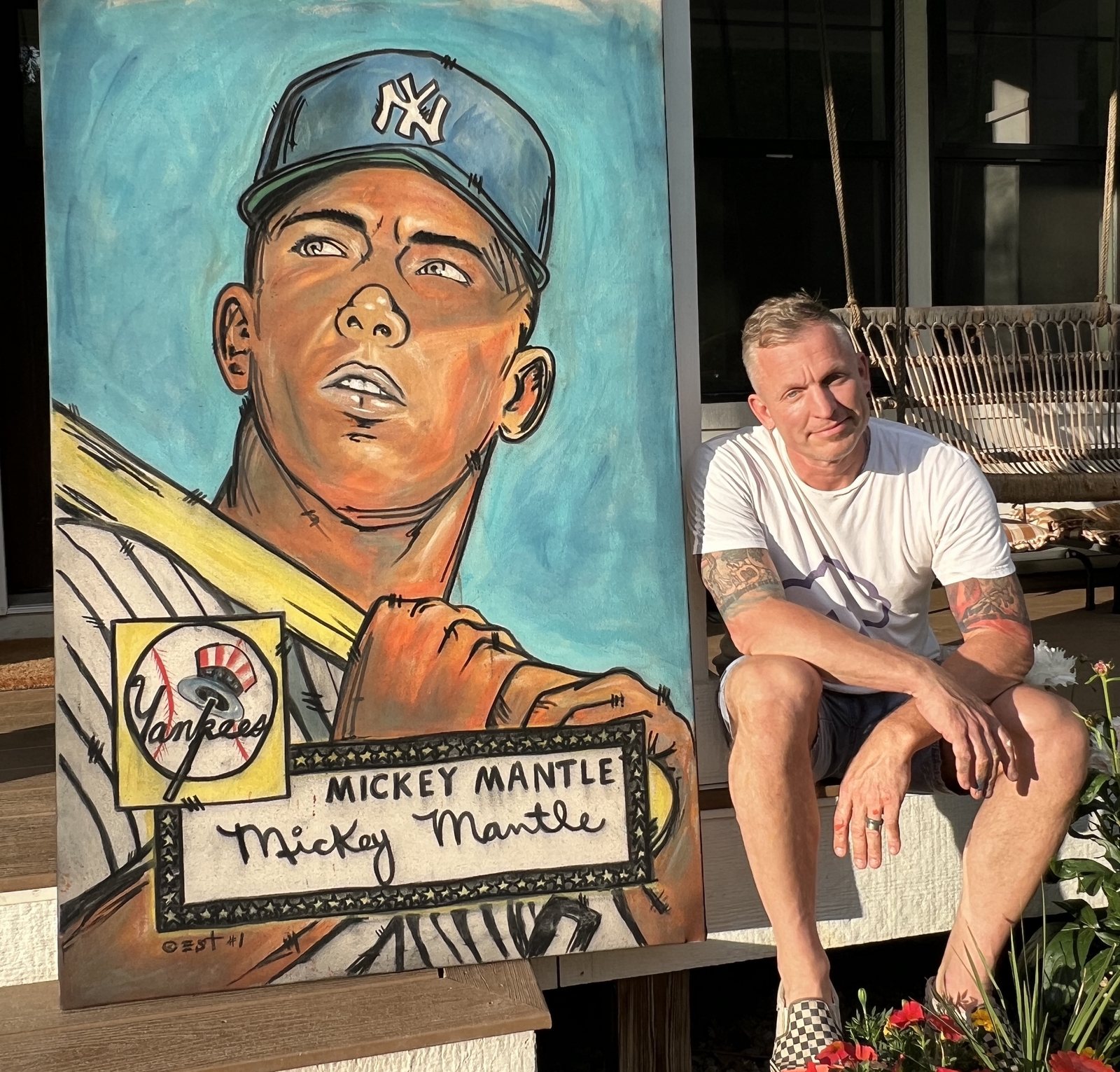 Eric Samuel Timm sitting beside his Mickey Mantle painting
